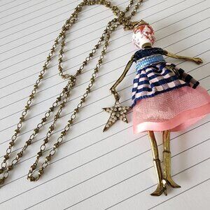 RS PARIS ARTICULATING DOLL PENDANT WITH EMBELLISHMENTS
